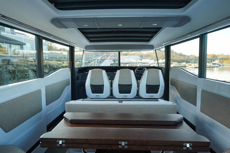 Slide: The Image of Interior of 2024 Axopar 45 boat with modern seating and panoramic windows. - 6