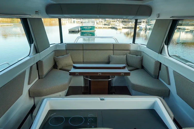 Slide: The Image of Interior of 2024 Axopar 45 boat with seating area and table. - 8
