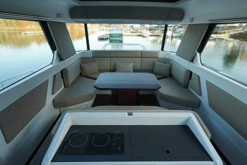 Slide: The Image of Interior of 2024 Axopar 45 boat with seating area and kitchenette. - 9