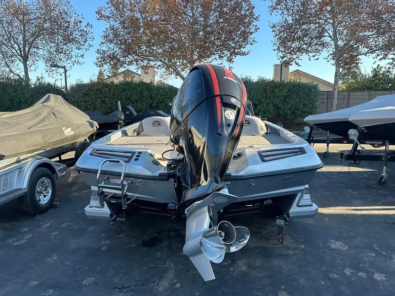 Slide: The Image of 2024 Ranger Z518 boat with powerful outboard motor, parked outdoors. - 3