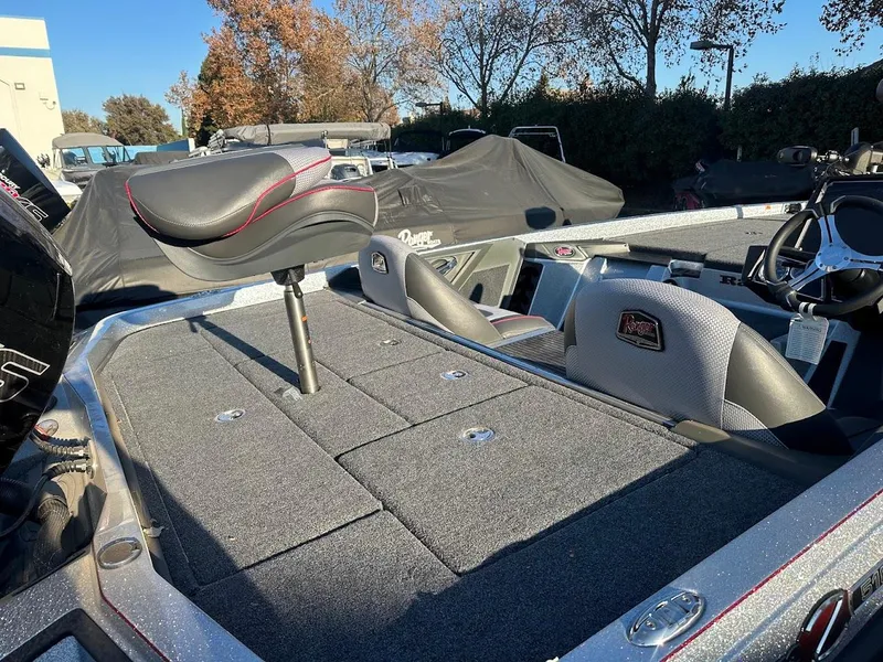 Slide: The Image of 2024 Ranger Z518 boat interior with gray seating and storage compartments. - 4