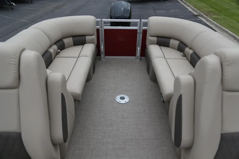 Slide: The Image of 2024 Sun Tracker Party Barge 24 DLX interior with beige seating and spacious layout. - 3