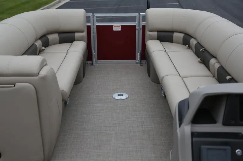 Slide: The Image of 2024 Sun Tracker Party Barge 24 DLX interior with beige seating and spacious layout. - 4