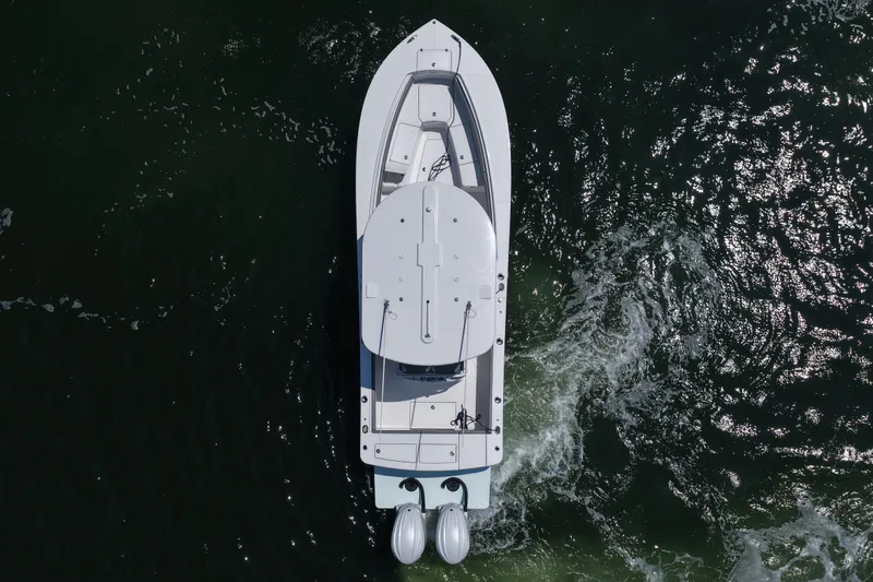 Slide: The Image of Overhead view of 2025 Regulator 28 boat cruising on water. - 14