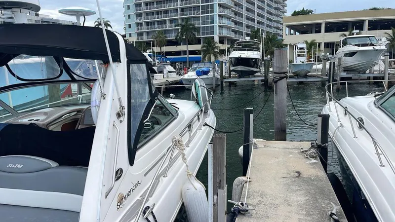 Slide: The Image of Sea Ray 340 Sundancer 2002 docked at a marina with other boats. - 13