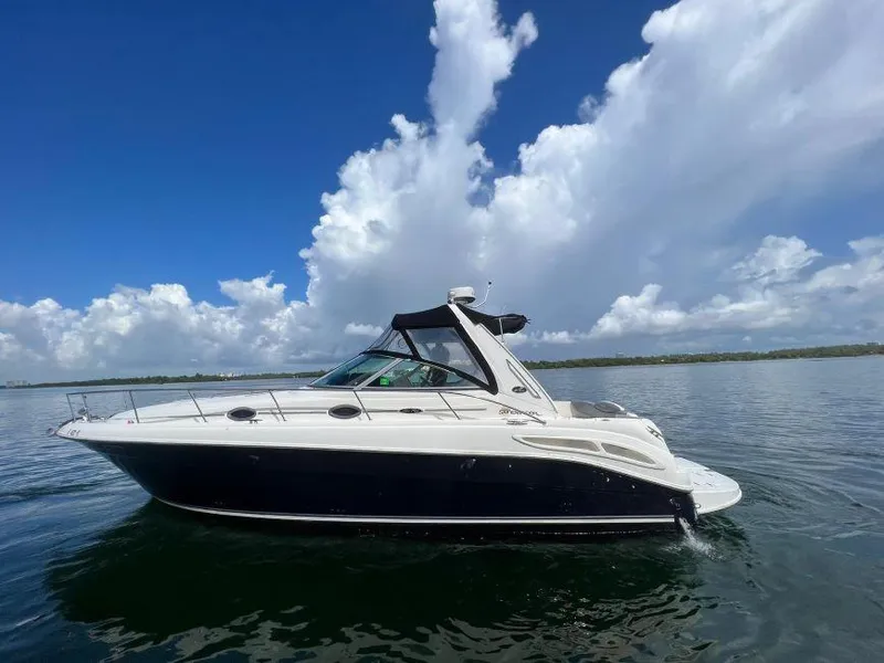 Slide: The Image of 2002 Sea Ray 340 Sundancer yacht on calm waters under a blue sky. - 3