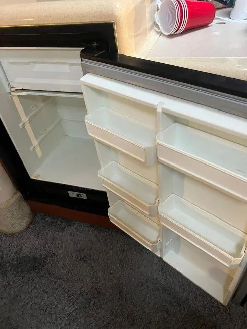 Slide: The Image of Open refrigerator inside a 2002 Sea Ray 340 Sundancer boat with red cups on the counter. - 4