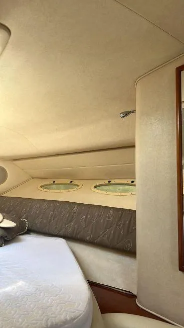 Slide: The Image of Interior cabin of 2002 Sea Ray 340 Sundancer yacht with porthole windows. - 6