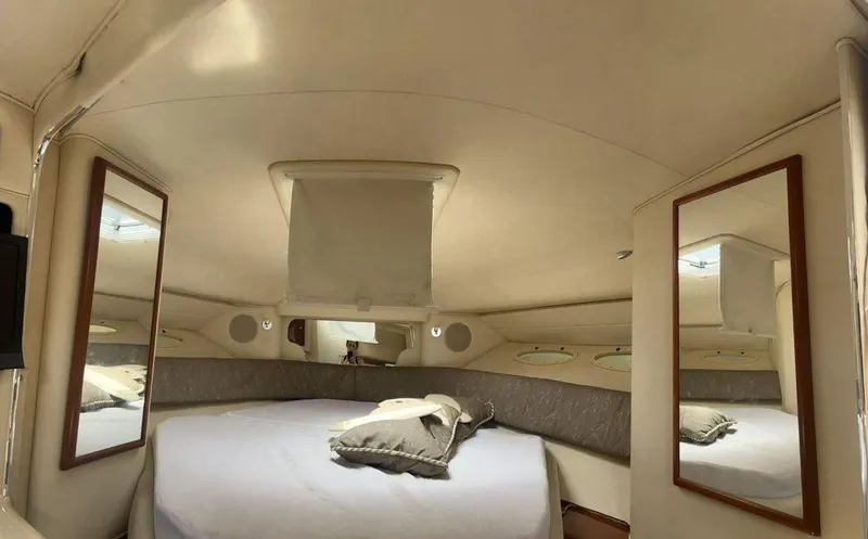 Slide: The Image of Interior cabin of 2002 Sea Ray 340 Sundancer with bed and mirrors. - 7