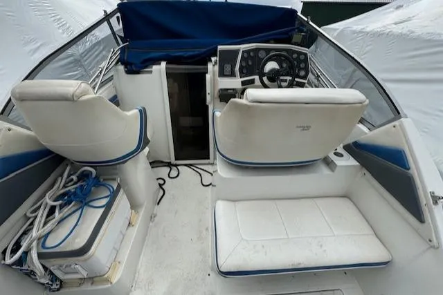Slide: The Image of 1993 Carver 280 Express boat interior with helm, seating, and storage. - 11
