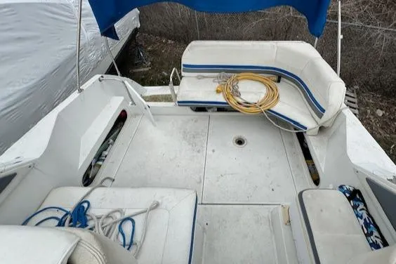 Slide: The Image of 1993 Carver 280 Express boat deck with seating and storage compartments. - 18