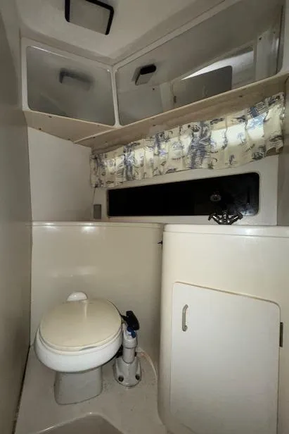 Slide: The Image of 1993 Carver 280 Express boat bathroom with toilet and sink. - 25