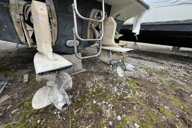 Slide: The Image of 1993 Carver 280 Express boat propellers and stern drives on dry land. - 28