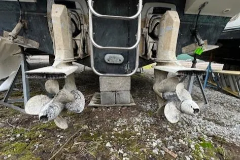 Slide: The Image of 1993 Carver 280 Express boat propellers and stern drives on dry land. - 29