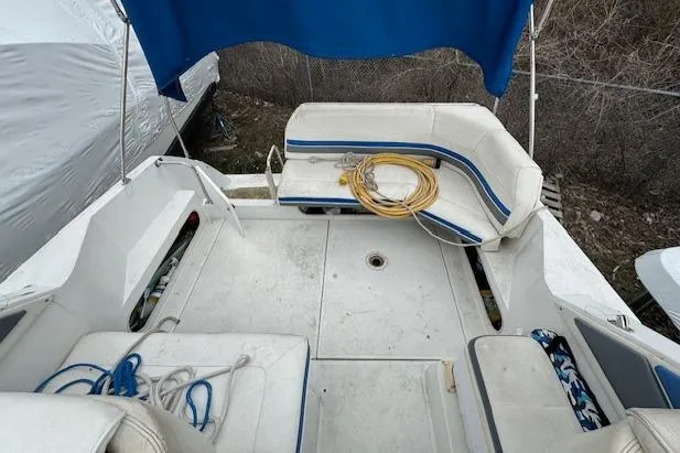 Slide: The Image of 1993 Carver 280 Express boat interior with seating and storage compartments. - 10