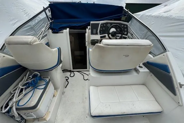 Slide: The Image of 1993 Carver 280 Express boat interior with white seating and control panel. - 17