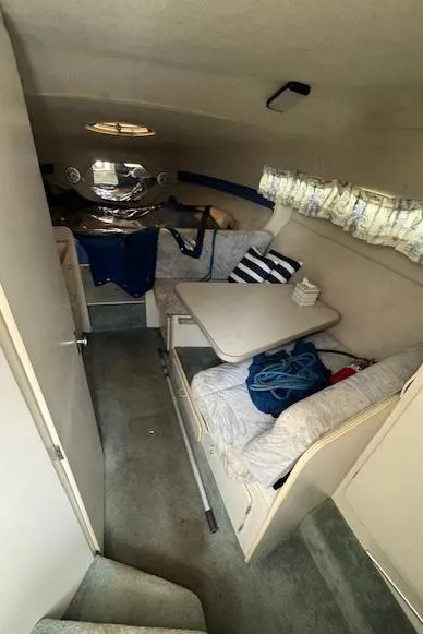 Slide: The Image of 1993 Carver 280 Express cabin interior with seating and table. - 27