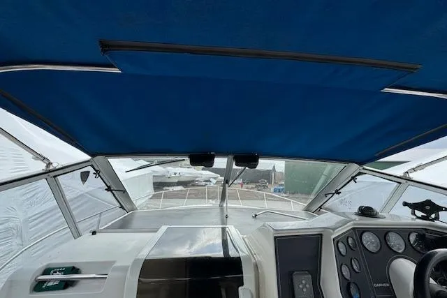 Slide: The Image of 1993 Carver 280 Express boat cockpit with blue canopy and control panel. - 3