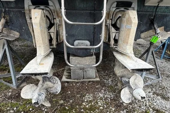 Slide: The Image of 1993 Carver 280 Express boat propellers and stern drive on dry land. - 30