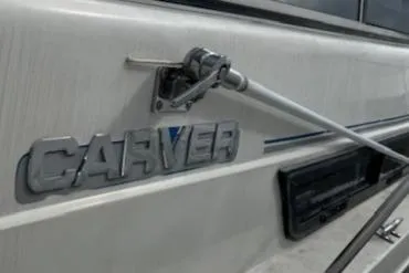 Slide: The Image of 1993 Carver 280 Express boat exterior with logo and hardware. - 31