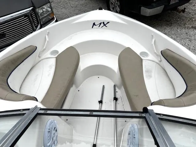 Slide: The Image of 2005 Glastron MX boat interior with beige seating and white hull. - 4