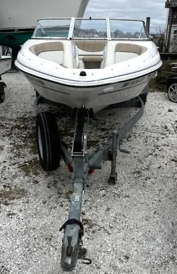 Slide: The Image of 2005 Glastron MX boat on trailer, parked on gravel. - 5