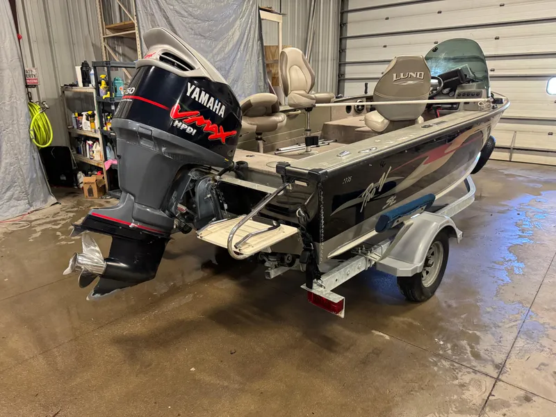 Slide: The Image of 2002 Lund 1775 Pro-V SE boat with Yamaha VMAX outboard motor in a garage. - 4