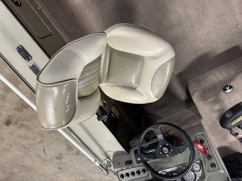 Slide: The Image of Interior of a 2002 Lund 1775 Pro-V SE boat showing steering wheel and seat. - 8