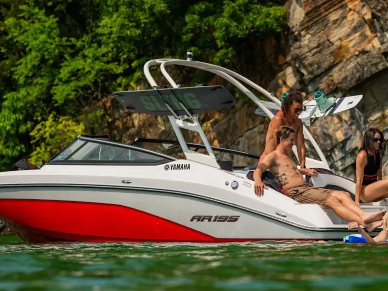 Slide: The Image of 2024 Yamaha Boats AR195 on a lake with people relaxing. - 4
