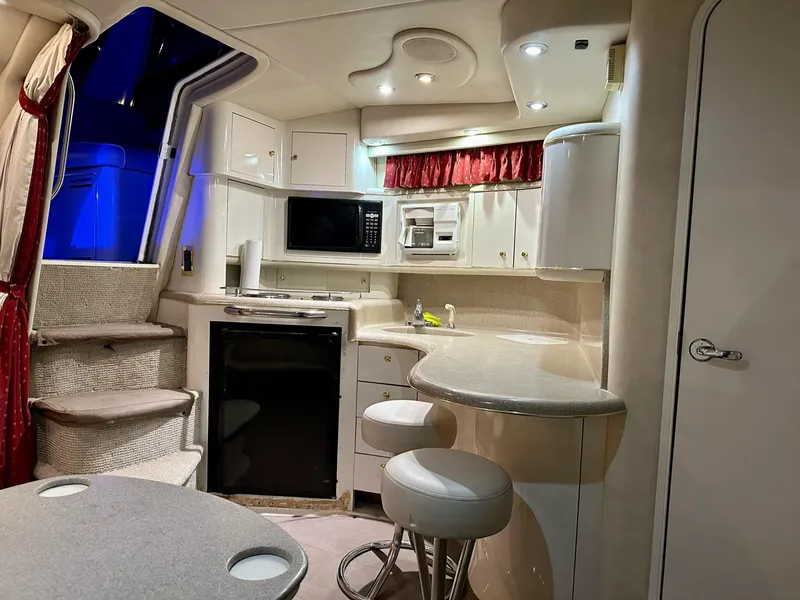 Slide: The Image of Interior of a 1997 Sea Ray 370 Sundancer yacht with modern kitchen amenities. - 10