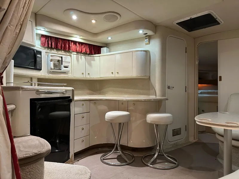 Slide: The Image of Luxurious interior of a 1997 Sea Ray 370 Sundancer yacht with modern kitchen amenities. - 11