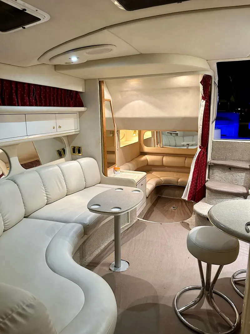Slide: The Image of Luxurious interior of a 1997 Sea Ray 370 Sundancer yacht with plush seating and modern decor. - 12