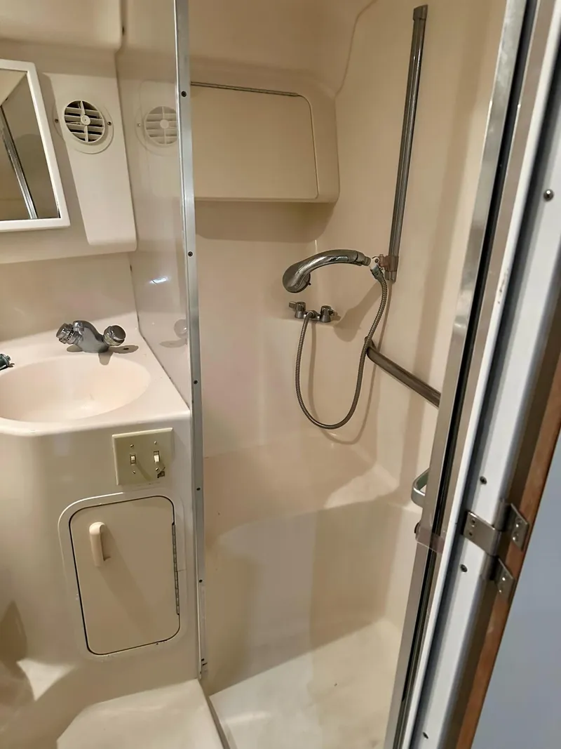 Slide: The Image of Bathroom interior of 1997 Sea Ray 370 Sundancer yacht, featuring shower and sink. - 15