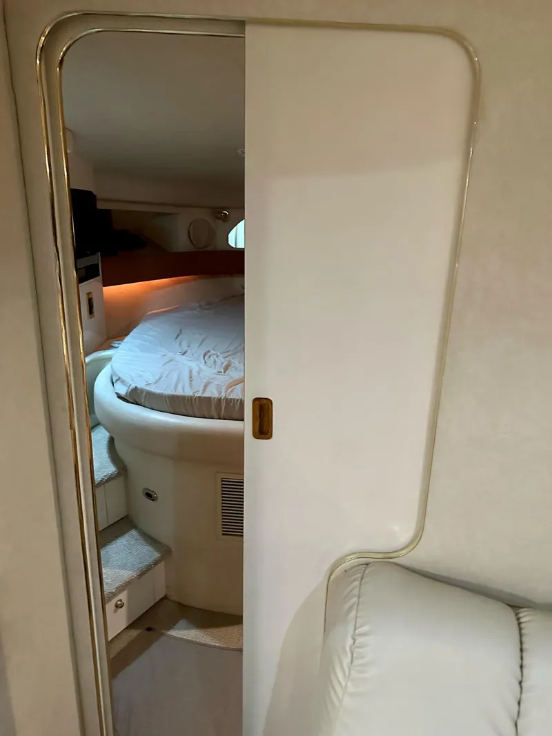 Slide: The Image of Interior cabin of 1997 Sea Ray 370 Sundancer with cozy bed and ambient lighting. - 18