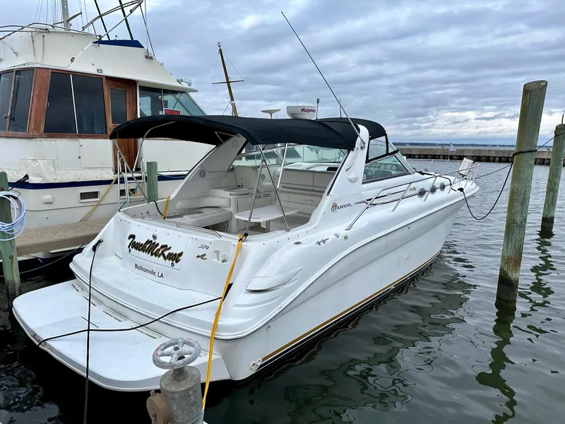 Slide: The Image of 1997 Sea Ray 370 Sundancer docked at marina, overcast sky. - 2