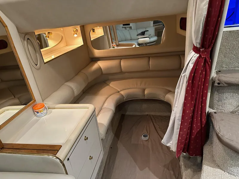 Slide: The Image of Interior of 1997 Sea Ray 370 Sundancer with beige seating and red curtains. - 22