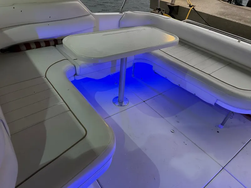 Slide: The Image of 1997 Sea Ray 370 Sundancer boat interior with blue LED lighting and white seating. - 6