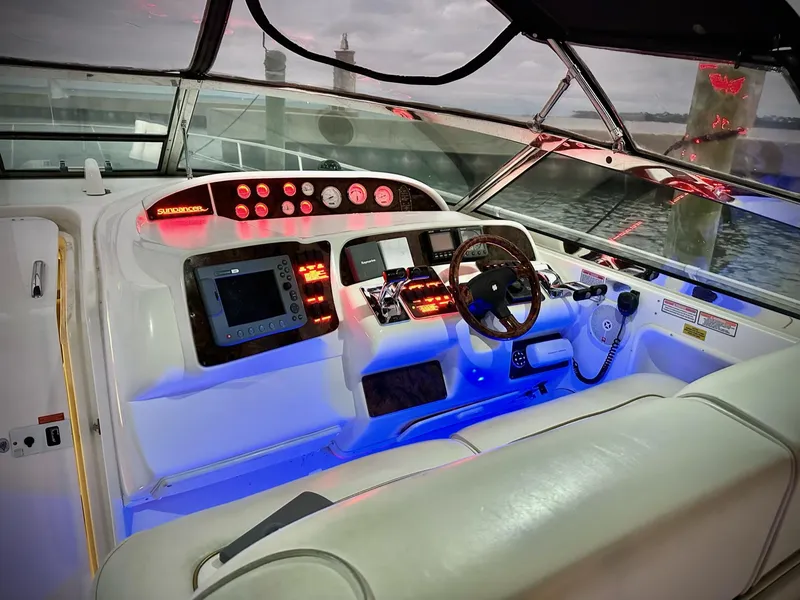 Slide: The Image of 1997 Sea Ray 370 Sundancer helm with illuminated controls and steering wheel. - 7