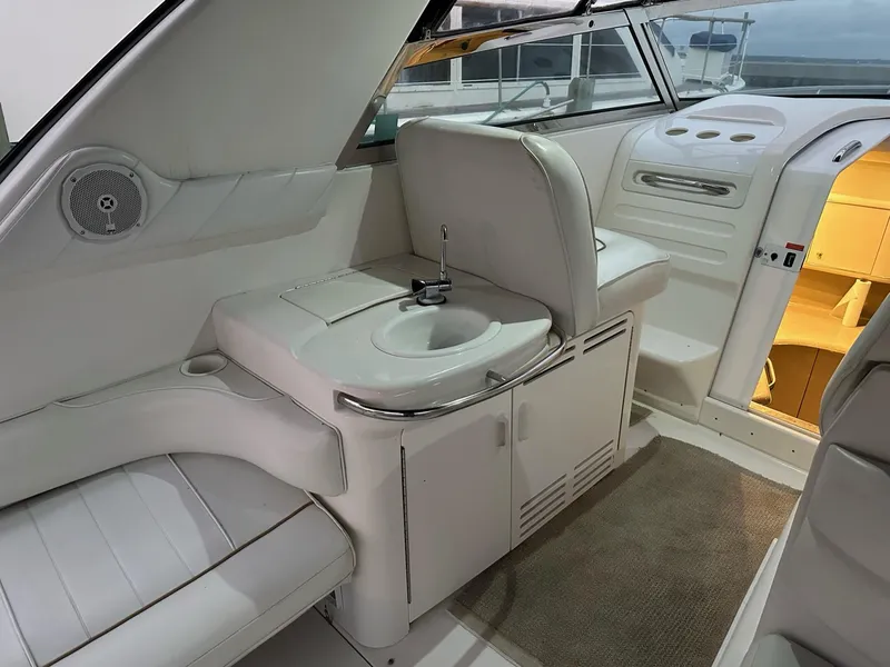 Slide: The Image of 1997 Sea Ray 370 Sundancer interior with sink, seating, and cabin entrance. - 9