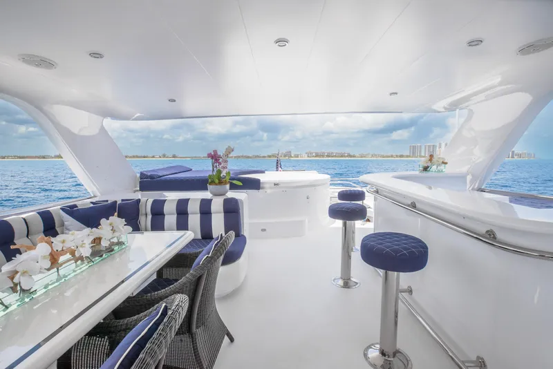 Slide: The Image of Luxurious interior of 2005 Horizon 94 Motoryacht with ocean view, bar stools, and dining area. - 12
