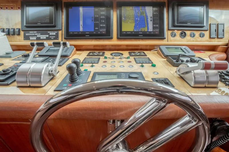 Slide: The Image of Control panel of a 2005 Horizon 94 Motoryacht with navigation screens and steering wheel. - 23