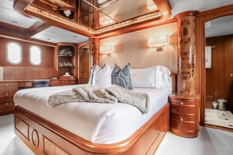 Slide: The Image of Luxurious master bedroom on a 2005 Horizon 94 Motoryacht with elegant wood finishes. - 28
