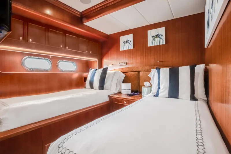 Slide: The Image of Luxurious twin cabin on 2005 Horizon 94 Motoryacht with wooden interiors and nautical decor. - 34