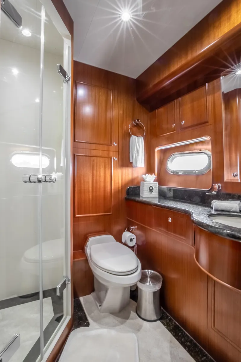 Slide: The Image of Luxurious bathroom on a 2005 Horizon 94 Motoryacht with wooden cabinetry and modern fixtures. - 36
