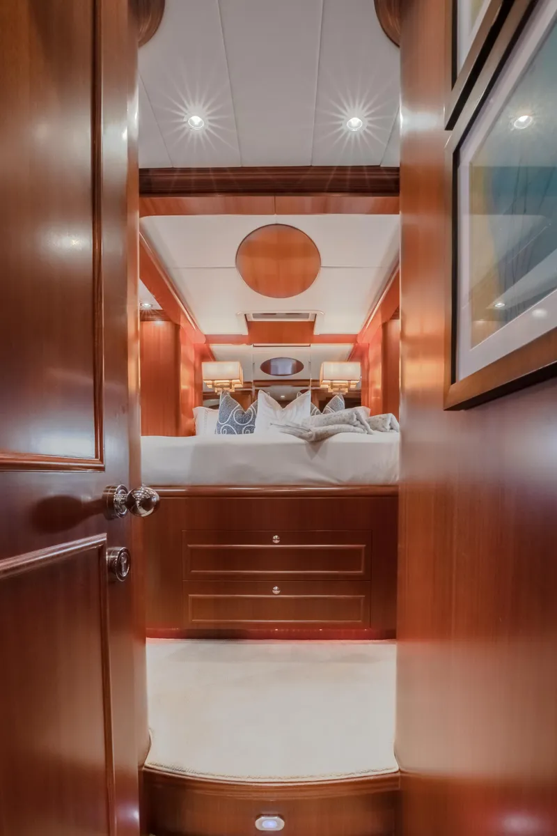 Slide: The Image of Luxurious bedroom interior of 2005 Horizon 94 Motoryacht with wooden finishes and ambient lighting. - 38
