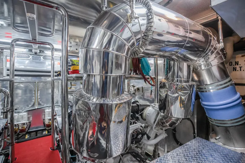Slide: The Image of Engine room of a 2005 Horizon 94 Motoryacht with polished metal pipes and machinery. - 46