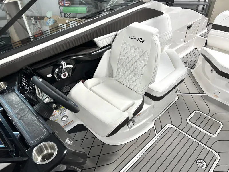Slide: The Image of 2024 Sea Ray SLX 260 boat interior with luxurious seating and modern dashboard. - 14