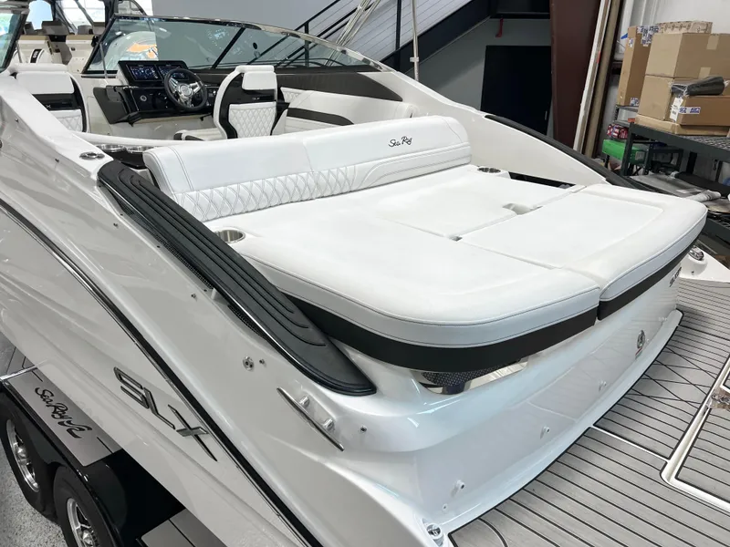 Slide: The Image of 2024 Sea Ray SLX 260 boat with luxurious white seating and modern dashboard. - 20