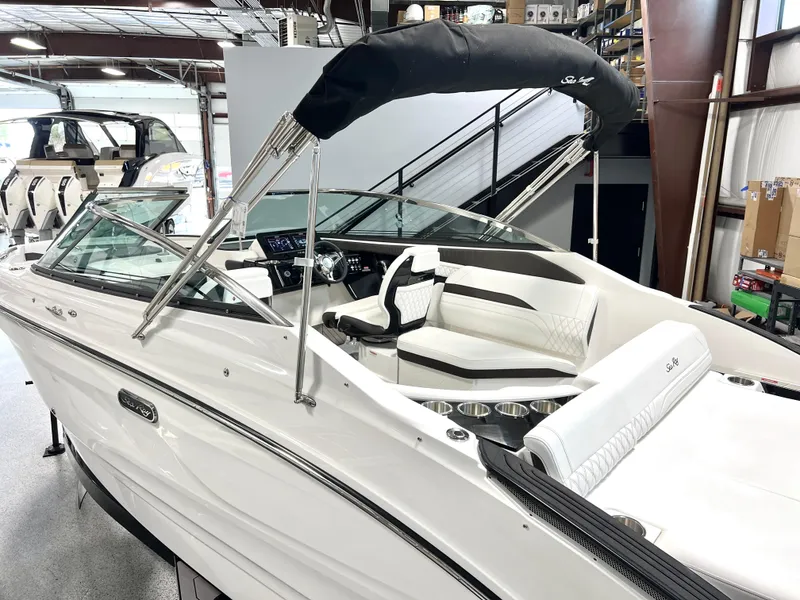Slide: The Image of 2024 Sea Ray SLX 260 boat with sleek design in showroom. - 22