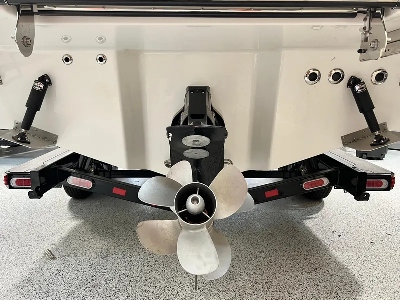 Slide: The Image of 2024 Sea Ray SLX 260 boat stern with propeller and trailer. - 25